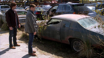 Sam and Dean pause to look at Bobby's old car. Sam and Dean pause to look at Bobby's old car.